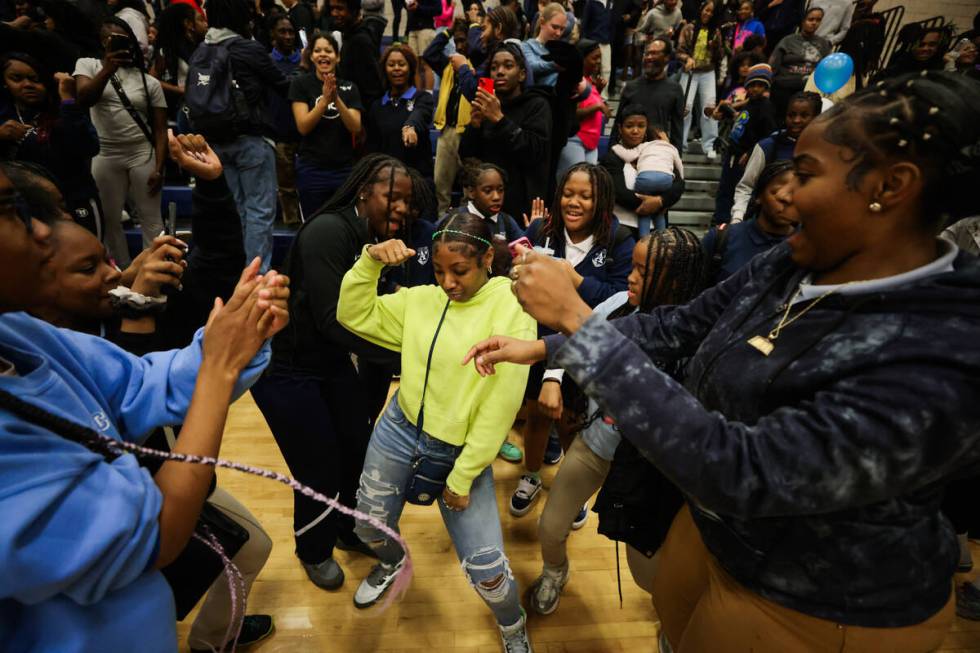 Democracy prep fans dance after their team won during a boys basketball game between Mater East ...