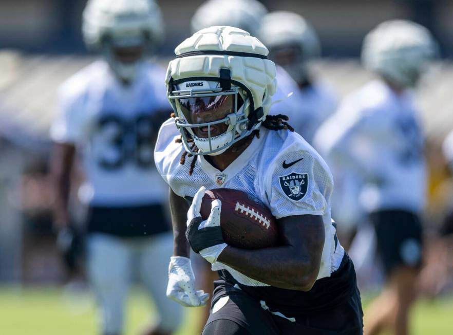 Raiders running back Sincere McCormick (28) cuts up field on a run during the second day of Rai ...