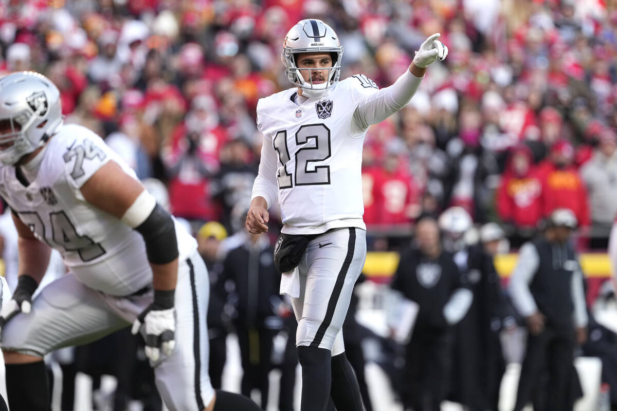 Las Vegas Raiders quarterback Aidan O'Connell sets up the offense during an NFL football game a ...