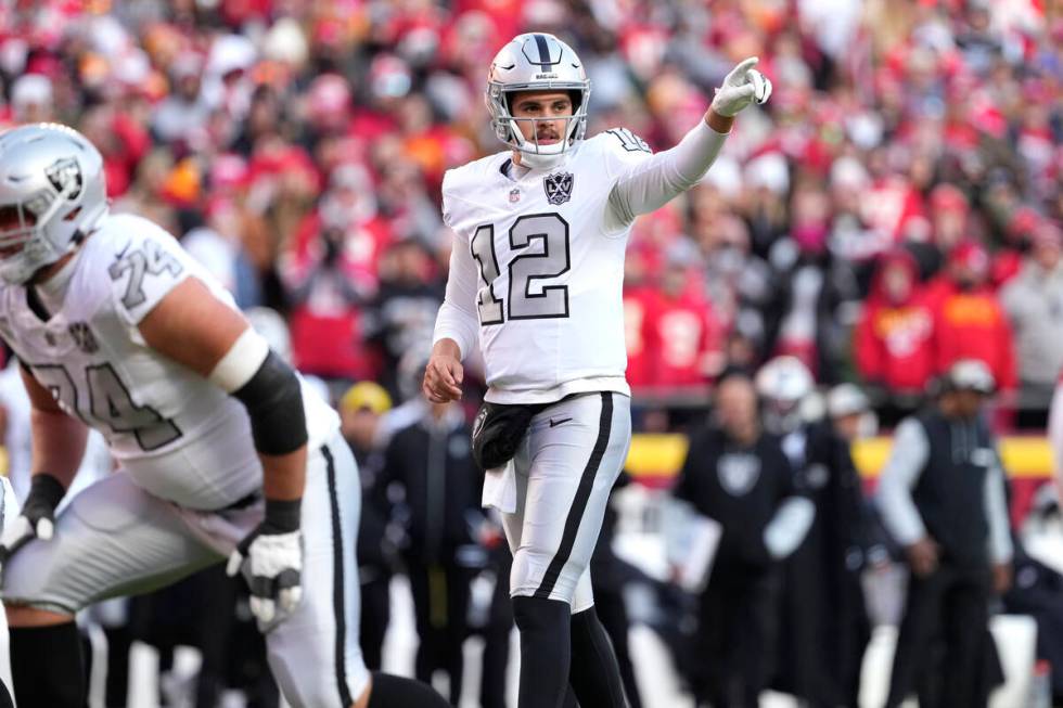 Las Vegas Raiders quarterback Aidan O'Connell sets up the offense during an NFL football game a ...