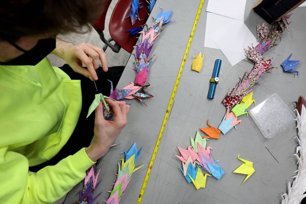 UNLV journalism and media studies major Austin Sommer prepares some of 4,000 paper cranes Wedne ...