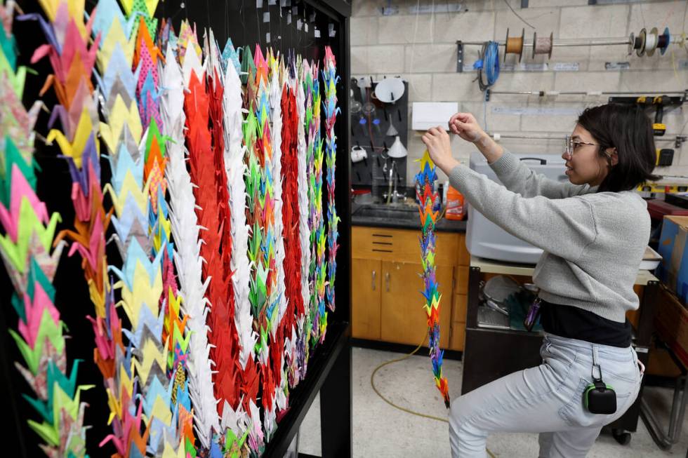 UNLV chemistry graduate student Rin Ruby prepares some of 4,000 paper cranes Wednesday, Dec. 4, ...