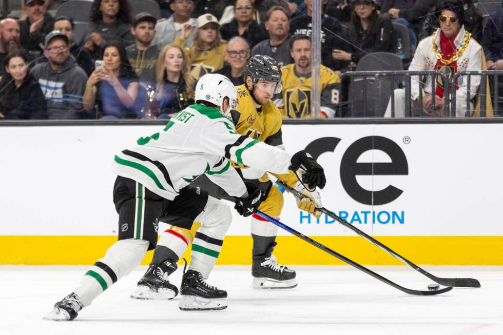 Golden Knights center Ivan Barbashev (49) looks to avoid Dallas Stars defenseman Nils Lundkvist ...