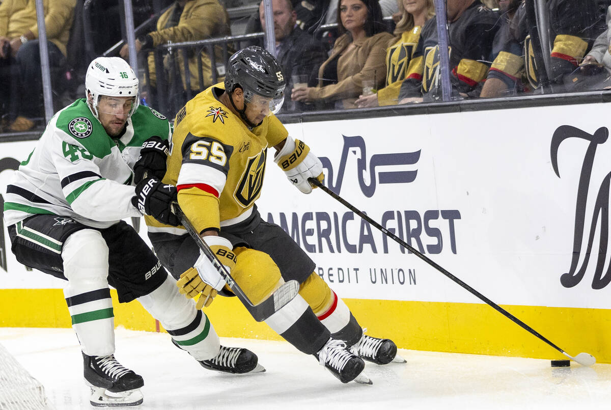 Golden Knights right wing Keegan Kolesar (55) keeps the puck from Dallas Stars defenseman Ilya ...