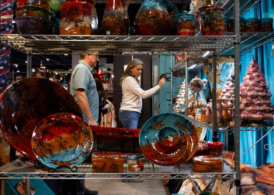 Shoppers check out ceramic artwork at the Orion Crossing booth at Cowboy Christmas at the Las V ...