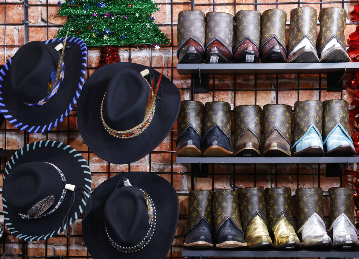 Custom made boots and hats are displayed at the Rocki Gorman booth at Cowboy Christmas at the L ...