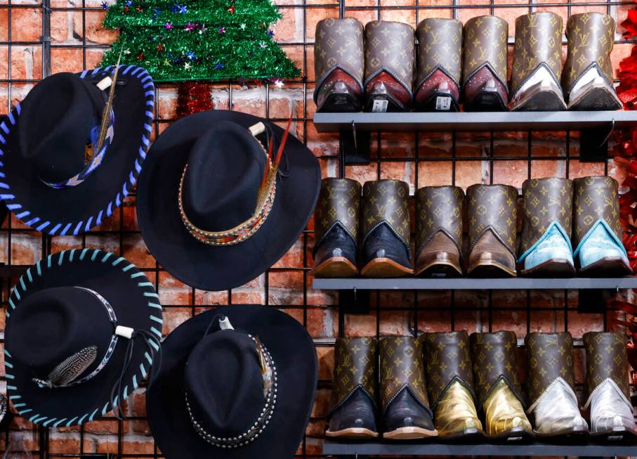 Custom made boots and hats are displayed at the Rocki Gorman booth at Cowboy Christmas at the L ...