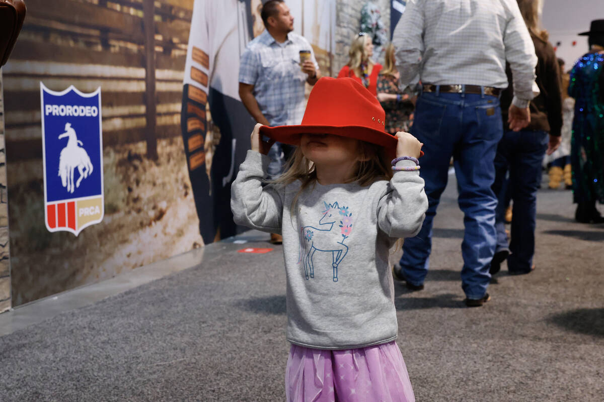 Rainey Wingo, 2, walks with her father, not seen, as they shop at Cowboy Christmas at the Las V ...