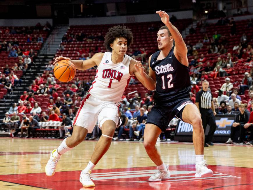 UNLV forward Jalen Hill (1) attempts to run past New Mexico State Aggies forward Peter Filipovi ...