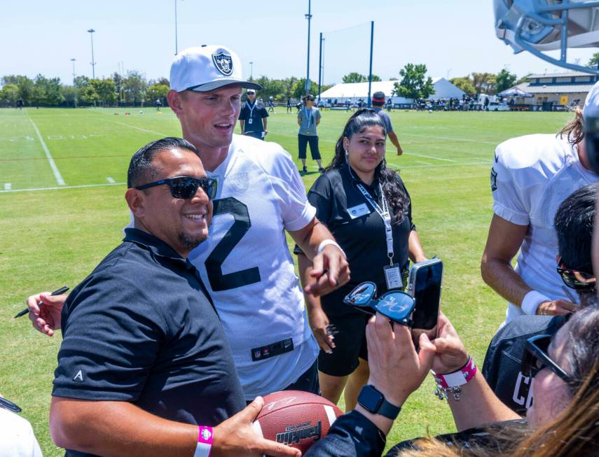 Raiders kicker Daniel Carlson (2) poses for a photo and signs autographs for fans following the ...