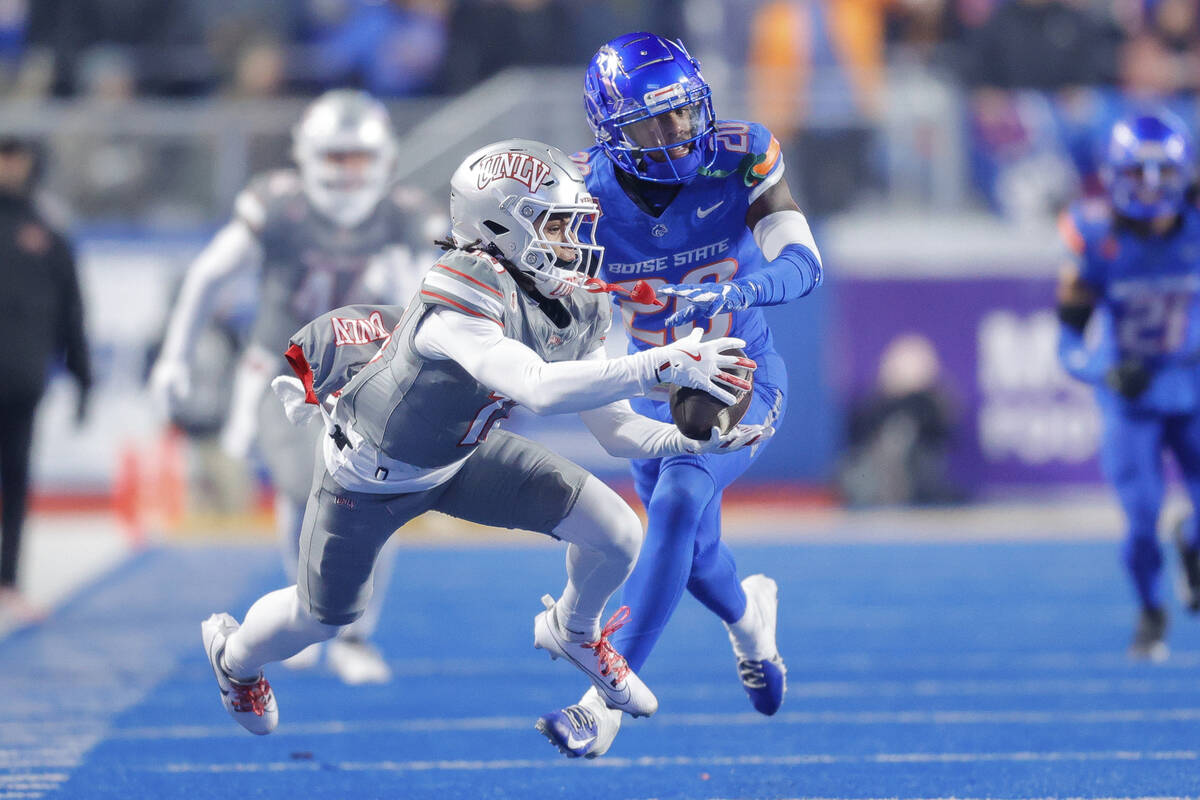 UNLV wide receiver Corey Thompson Jr. (13) catches the ball against Boise State cornerback Davo ...