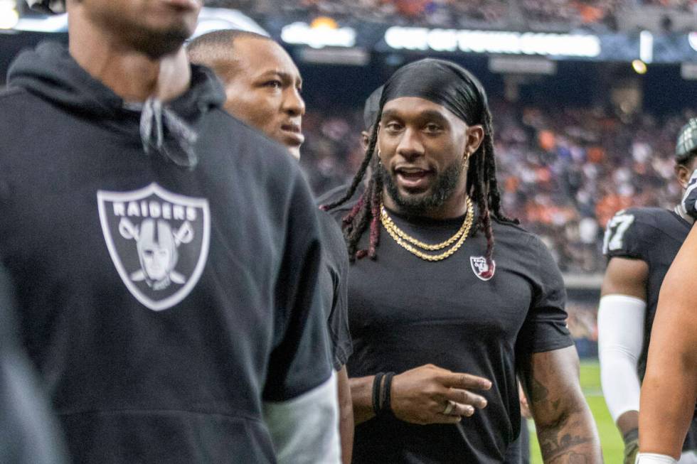 Raiders running back Alexander Mattison walks off the field for halftime of an NFL game against ...