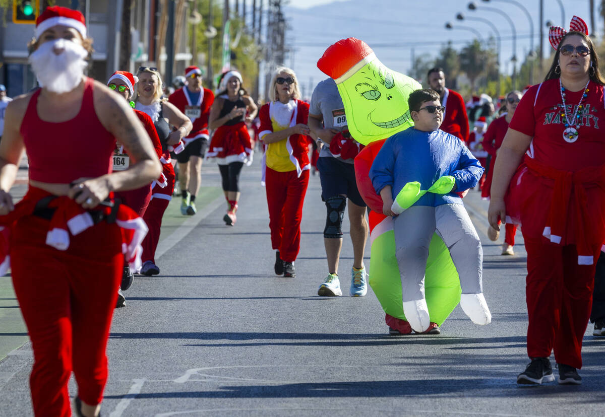 Entrants make their way along E. Bridger Avenue to the finish line in the 5K for the Las Vegas ...