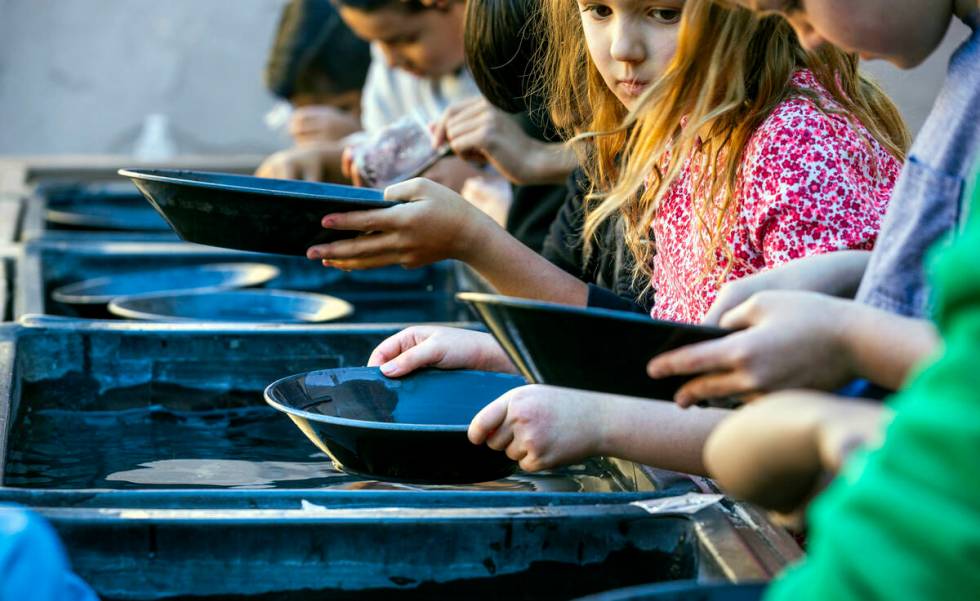 Kids learn the art of panning in a class at The Mine Experience within the Gordon McCaw STEAM A ...