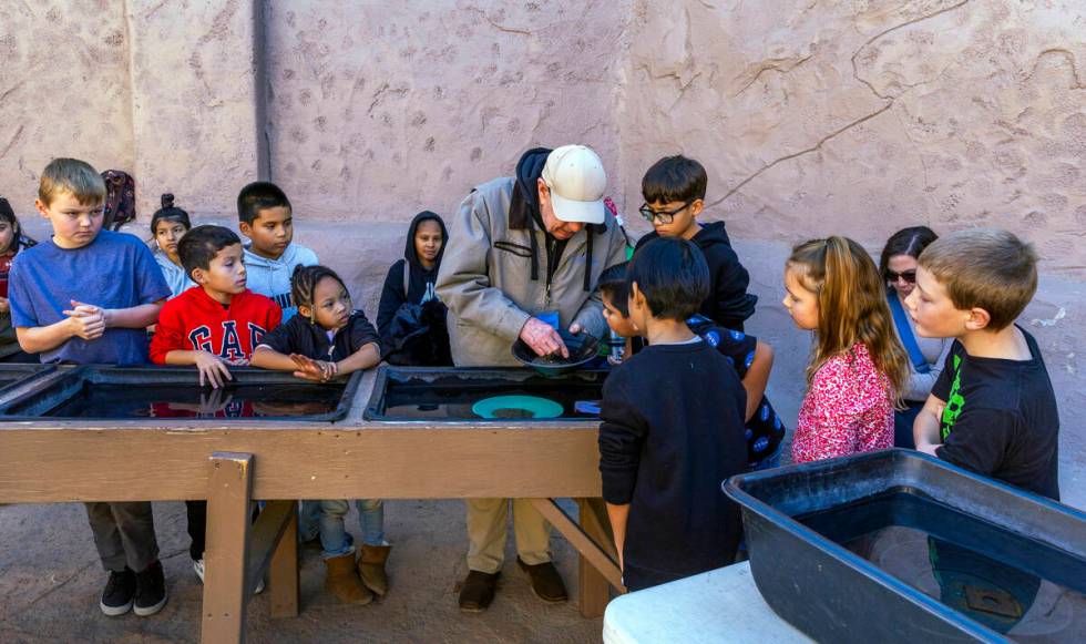 Instructor Bill Durbin teaches children the art of panning in a class at The Mine Experience wi ...