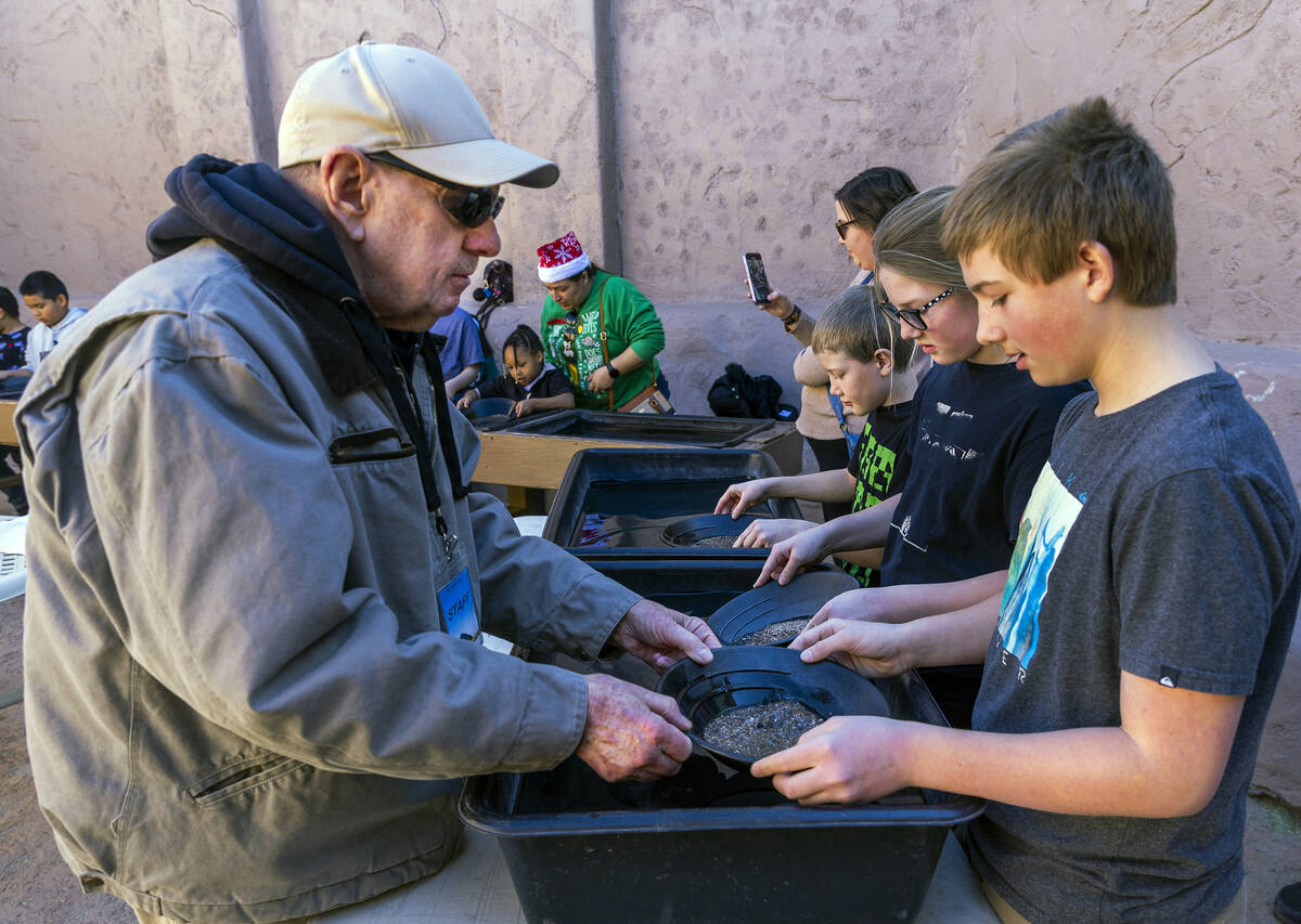 Instructor Bill Durbin helps Bentley Davis, 12, of Layton, Utah, learn the art of panning in a ...