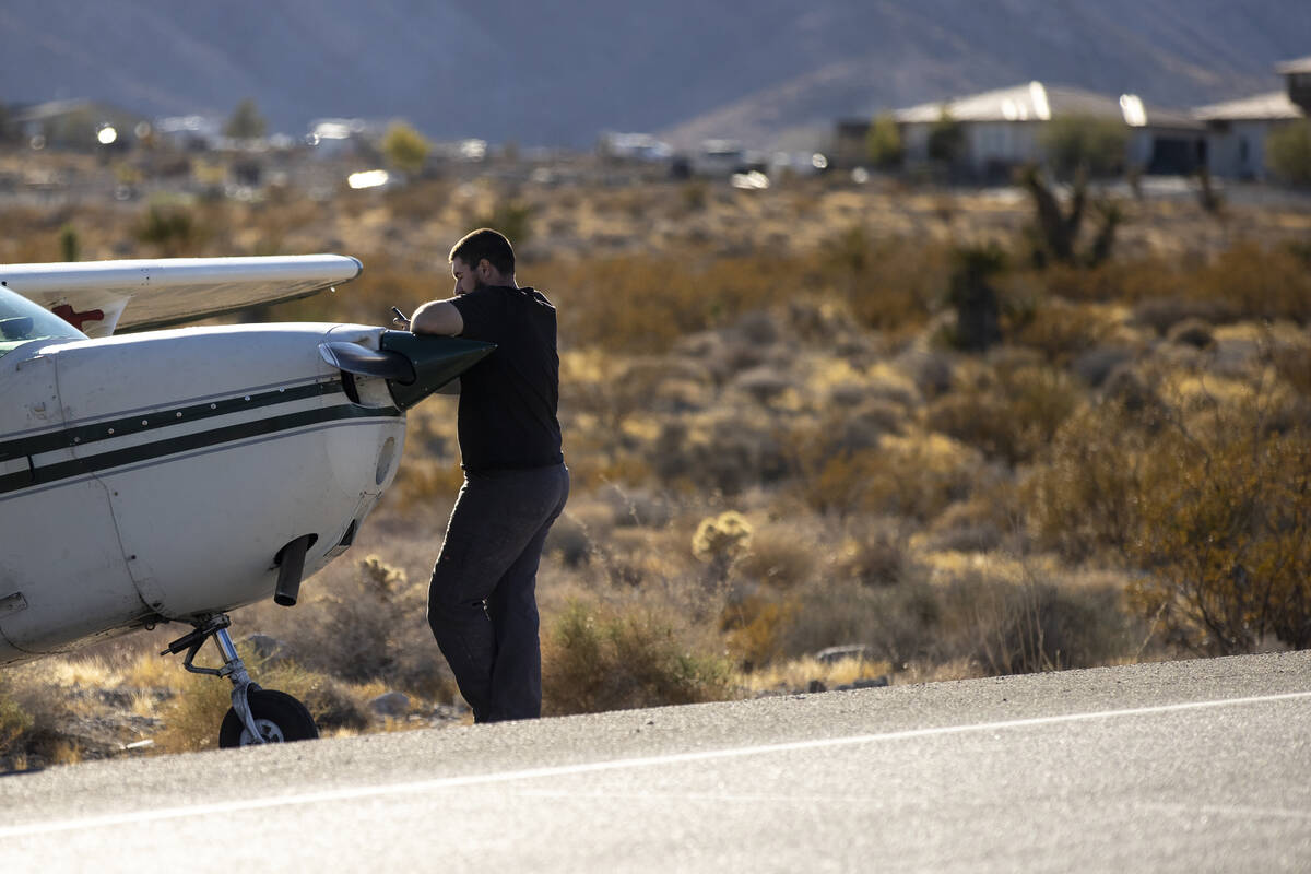 A man, who declined to give his name, leans on a plane after the plane emergency landed on Kyle ...