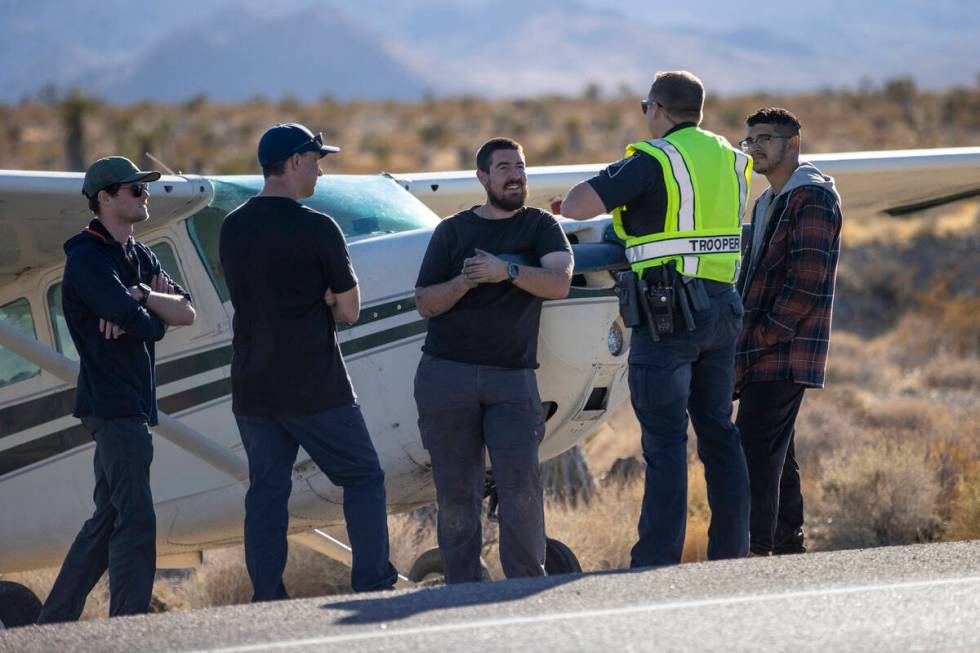 A crew of men, who declined to give their names, talk to Nevada Highway Patrol trooper Roy Eric ...