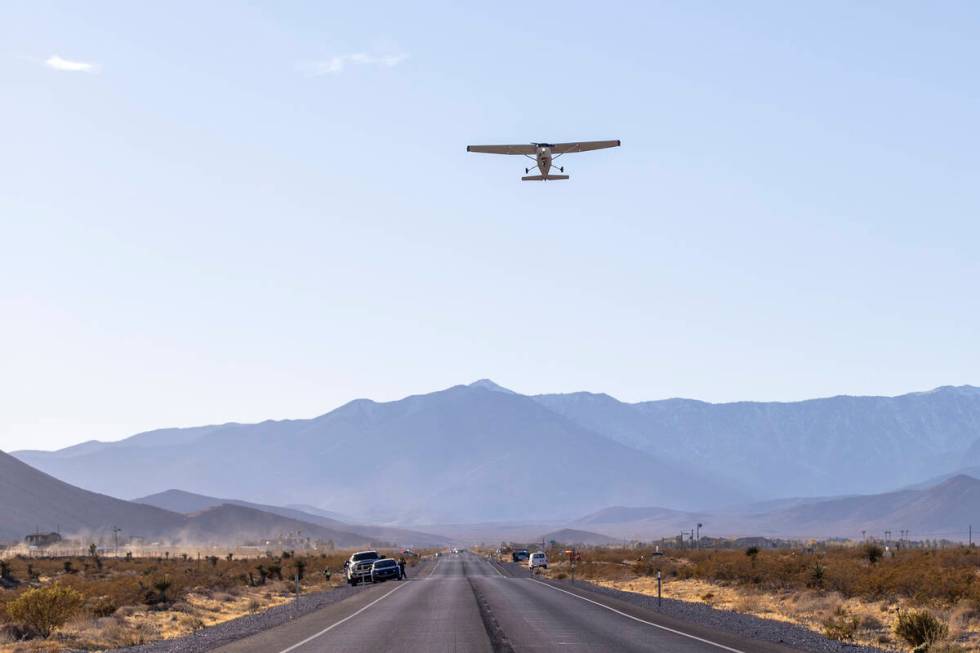 A plane successfully takes flight after it emergency landed on Kyle Canyon Road, Saturday, Dec. ...