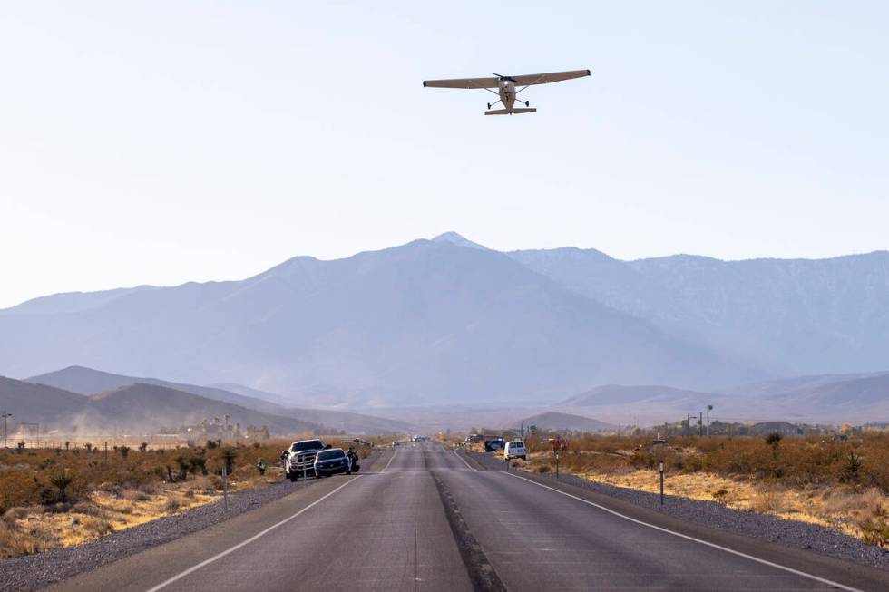 A plane successfully takes flight after it emergency landed on Kyle Canyon Road, Saturday, Dec. ...