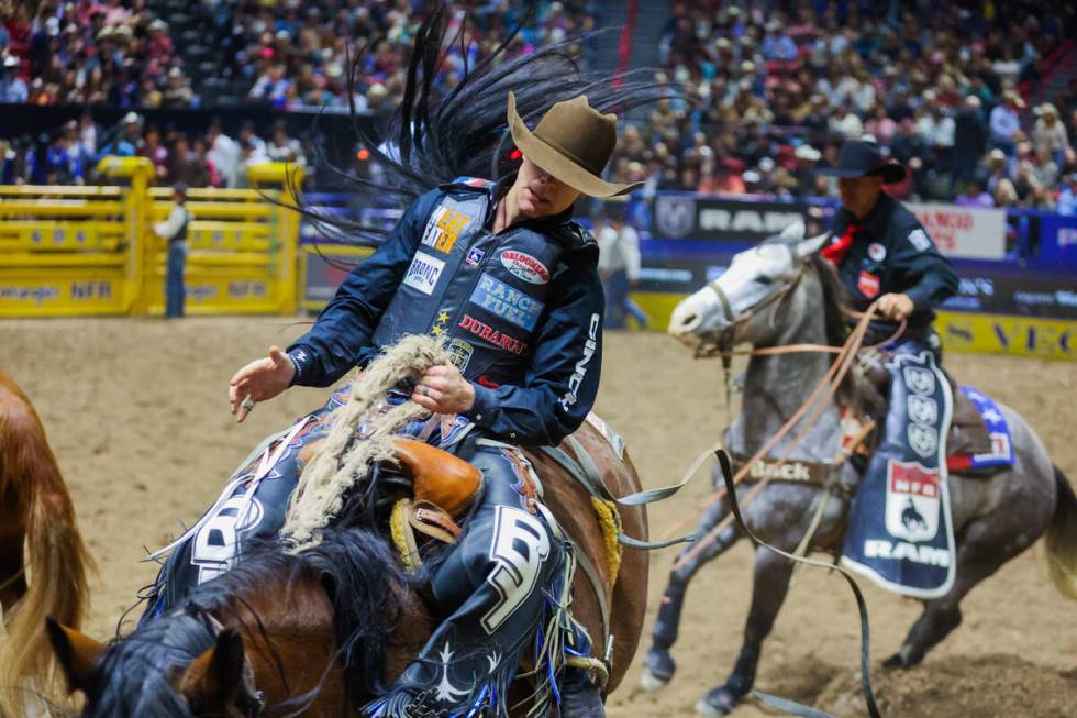 Saddle bronc rider Zeke Thurston rides Miss Valley during round three of the National Finals Ro ...