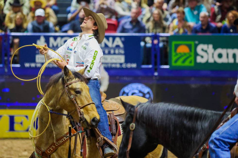 Tie-down roper Ty Harris looks up at his score during round three of the National Finals Rodeo ...