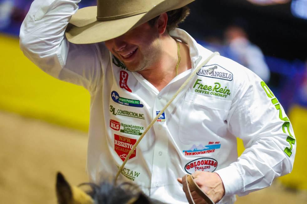 Tie-down roper Ty Harris takes his victory lap during round three of the National Finals Rodeo ...