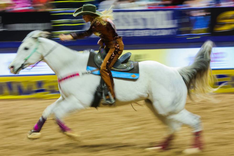 Barrel racer Tiany Schuster races out of the arena during round three of the National Finals Ro ...