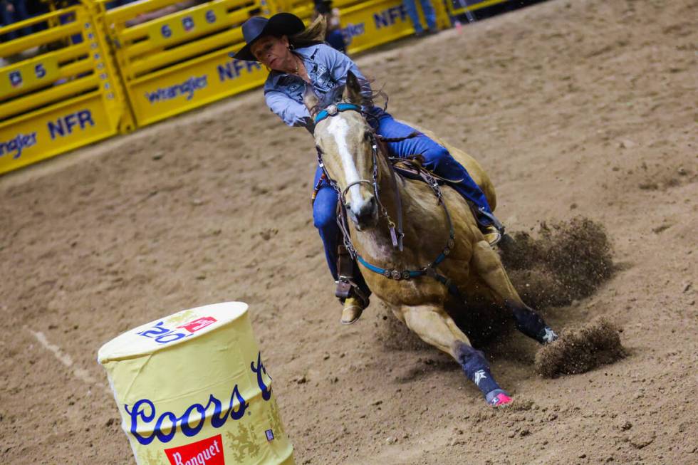 Barrel racer Shelley Morgan rounds a barrel during round three of the National Finals Rodeo at ...