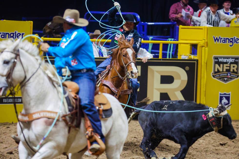 Team ropers Cyle Denison and Tanner Braden rope the calf during round three of the National Fin ...