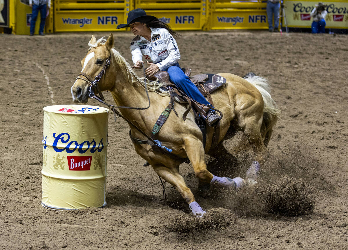 Barrel Racing competitor Hailey Kinsel navigates the first barrel on the way to a winning time ...