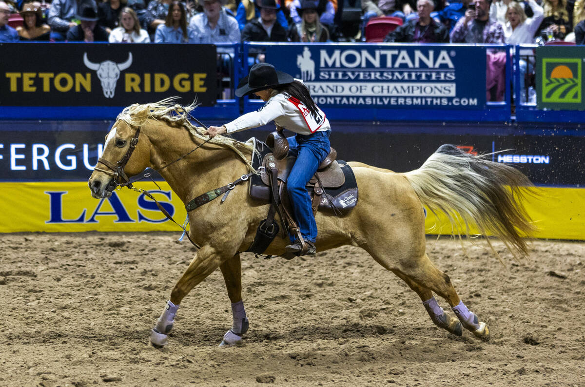 Barrel Racing competitor Hailey Kinsel heads to the fininsh on the way to a winning time during ...