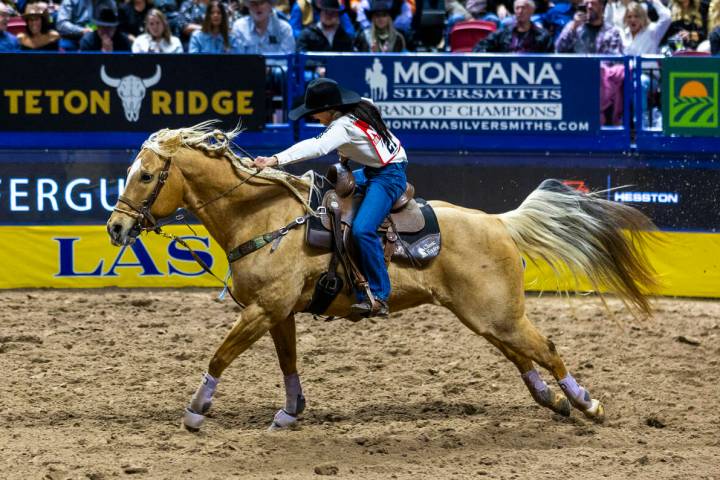 Barrel Racing competitor Hailey Kinsel heads to the fininsh on the way to a winning time during ...