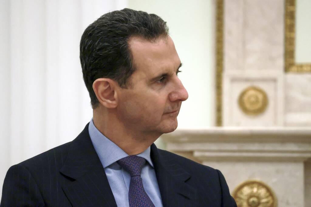 FILE - Syrian President Bashar Assad listens to Russian President Vladimir Putin during their m ...