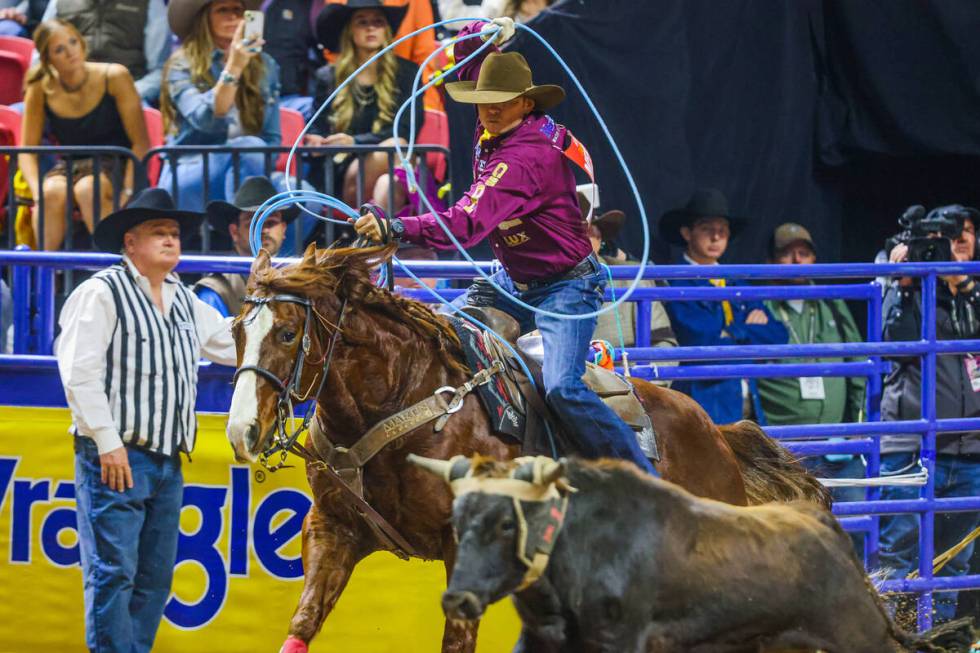 Team roper Hunter Koch rounds his rope up as he chases the calf during round four of the Nation ...