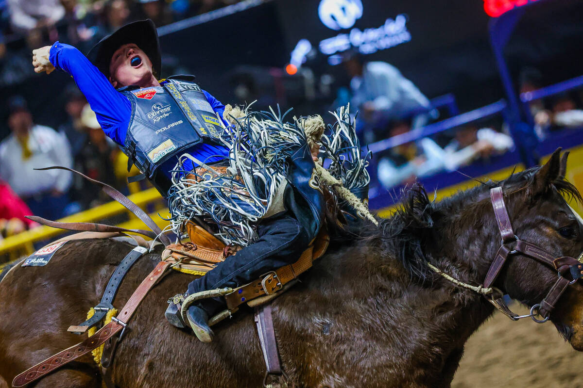 Saddle bronc rider Ryder Wright gets amped up during his ride on Tickled Pink during round four ...