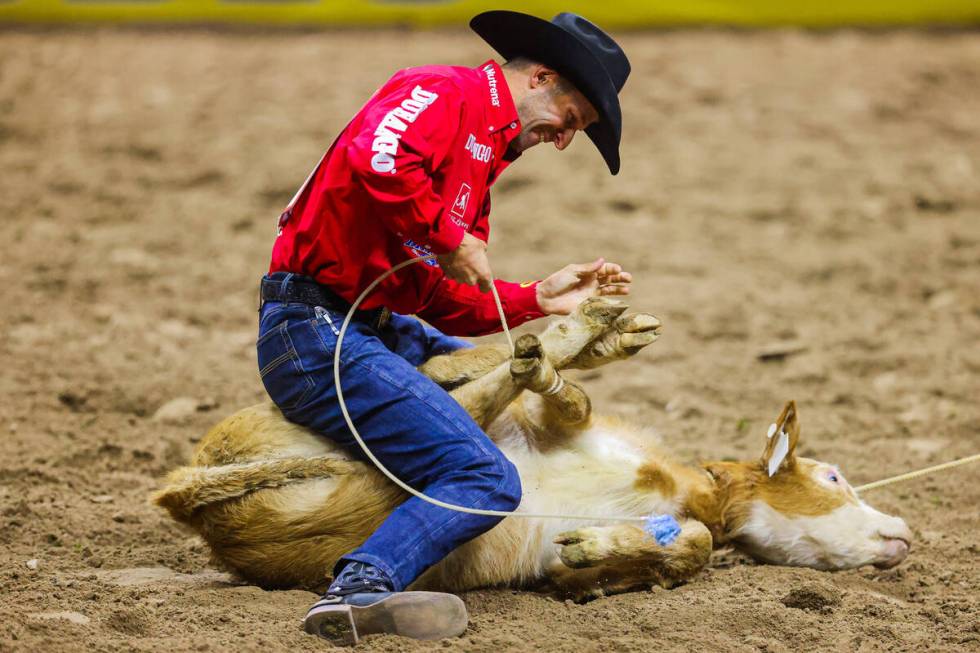 Tie-down roper Shane Hanchey smiles as he ropes his calf during round four of the National Fina ...