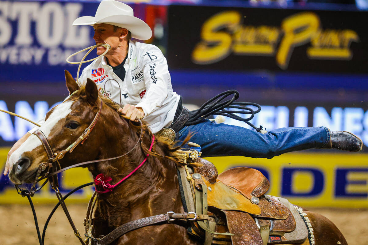 Tie-down Tuf Cooper gets off his horse to tie down the calf during round four of the National F ...