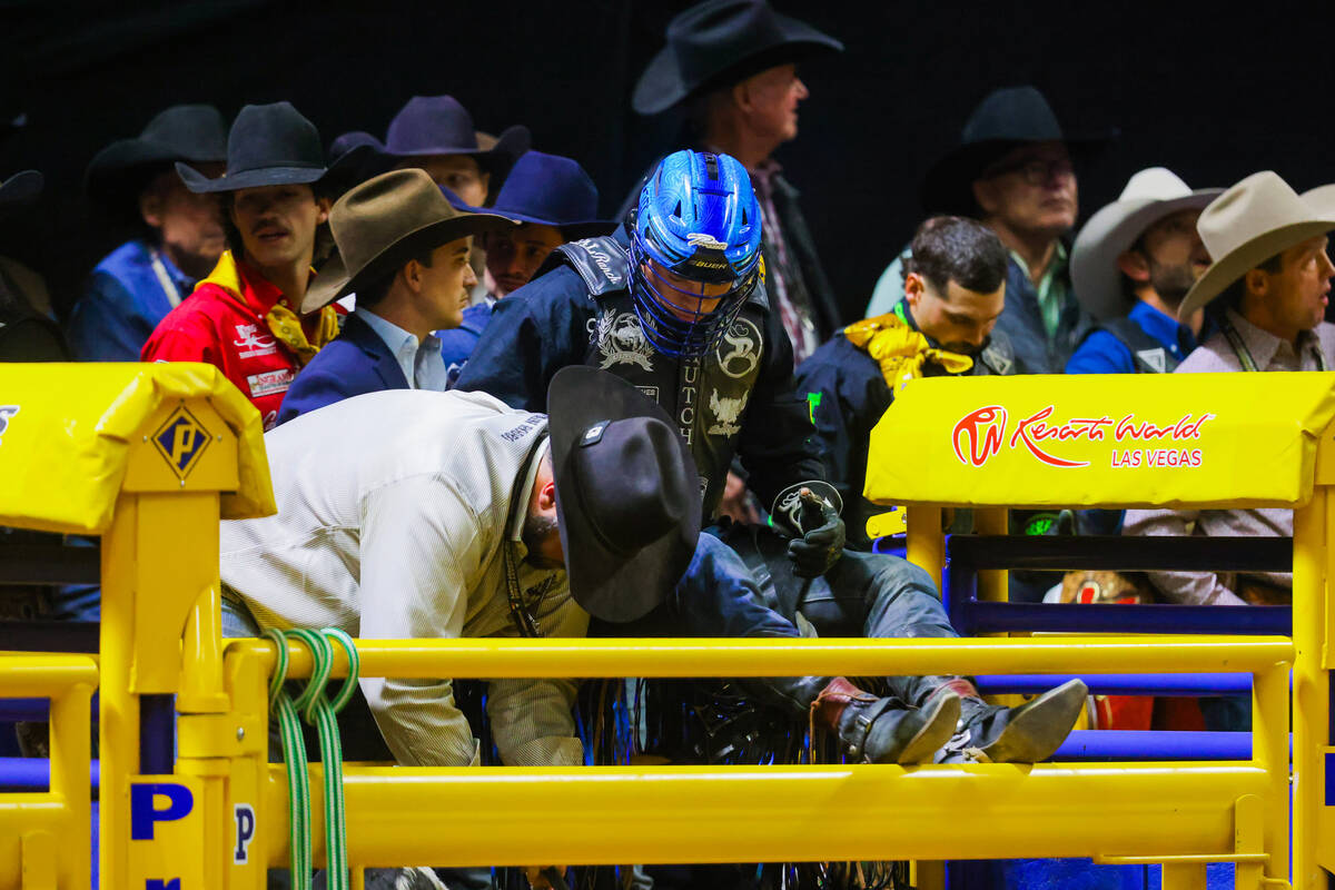 Bull rider Tristen Hutchings gets ready to ride Macho Man during round four of the National Fin ...