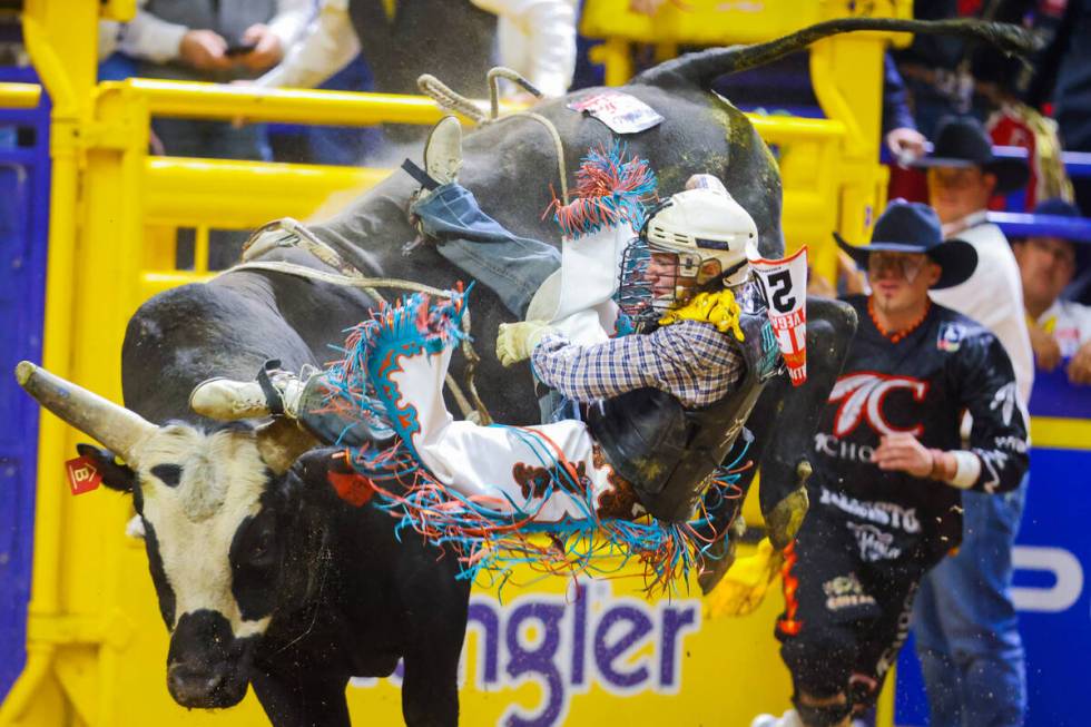 Bull rider Jeter Lawrence falls off of Sullivan during round four of the National Finals Rodeo ...