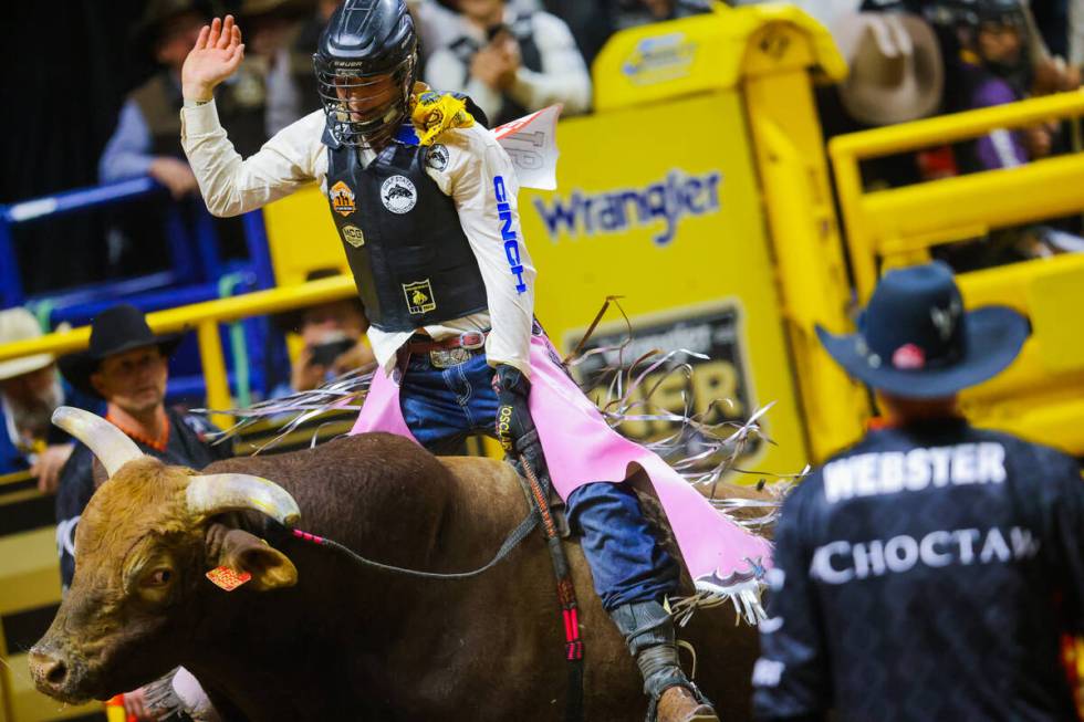 Bull rider Jace Trosclair rides Jagger during round four of the National Finals Rodeo at the Th ...