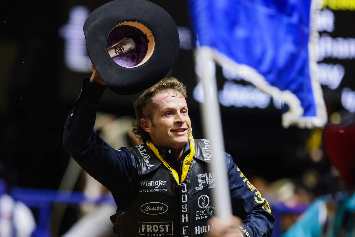 Bull rider Josh Frost takes his victory lap during round four of the National Finals Rodeo at t ...