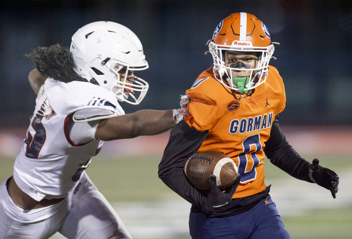 Bishop Gorman defensive back Isaiah Nickels (0) runs with a punt, avoiding Liberty offensive li ...