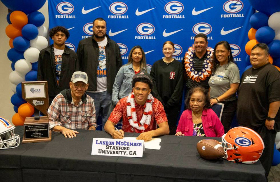 Bishop Gorman linebacker Landon McComber, center, signs a financial aid agreement with Stanford ...