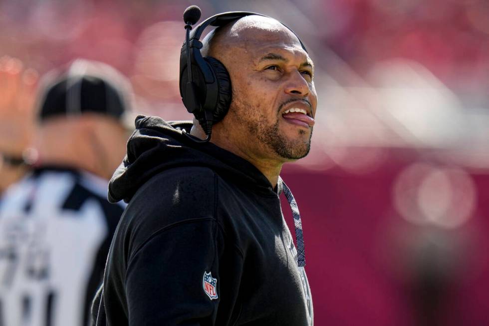 Las Vegas Raiders head coach Antonio Pierce looks at a replay during the first half of an NFL f ...