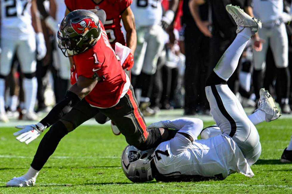 Las Vegas Raiders safety Tre'von Moehrig (7) tackles Tampa Bay Buccaneers running back Rachaad ...