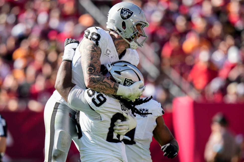 Las Vegas Raiders defensive tackle Adam Butler (69) celebrates with defensive end Maxx Crosby ( ...