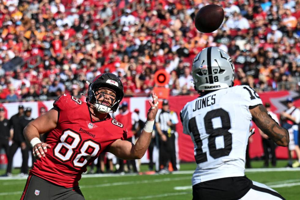 Las Vegas Raiders cornerback Jack Jones (18) prepares to intercept the ball from Tampa Bay Bucc ...