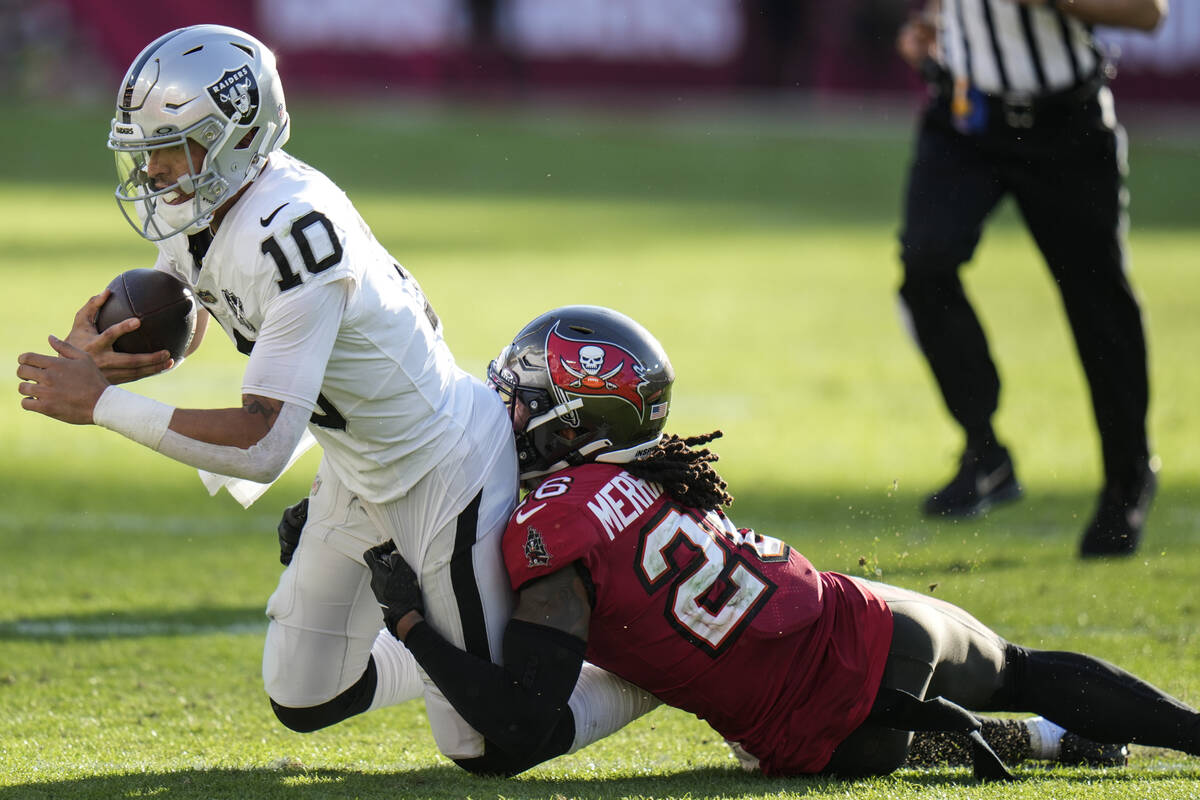 Tampa Bay Buccaneers safety Kaevon Merriweather (26) stops Las Vegas Raiders quarterback Desmon ...