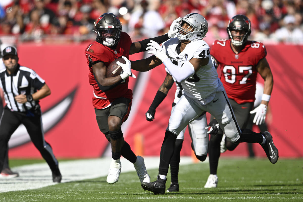 Tampa Bay Buccaneers running back Rachaad White (1) rushes for yardage in front of Las Vegas Ra ...